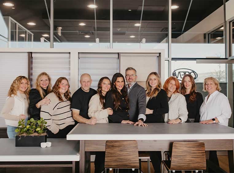 Company staff posing for a photo in the showroom